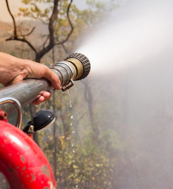 Firefighters Spray Water To Prevent Forest Fires From Spreading.